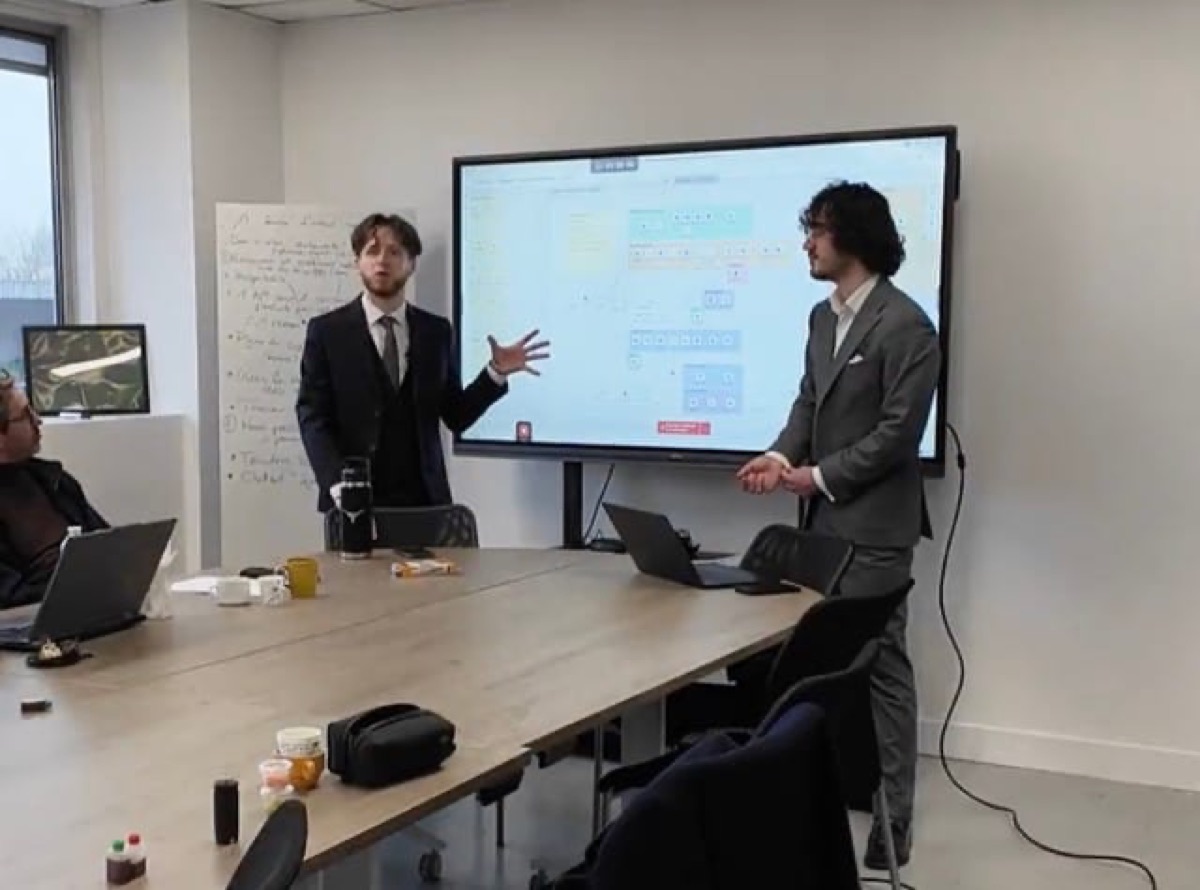 Clément Geynet and Enzo Donati presenting an automation workflow to a client team